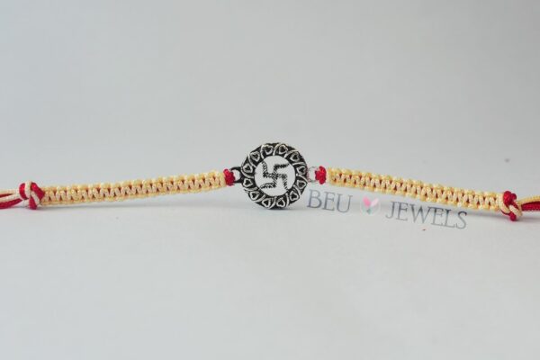 Swastik Silver Rakhi with Red and White Thread